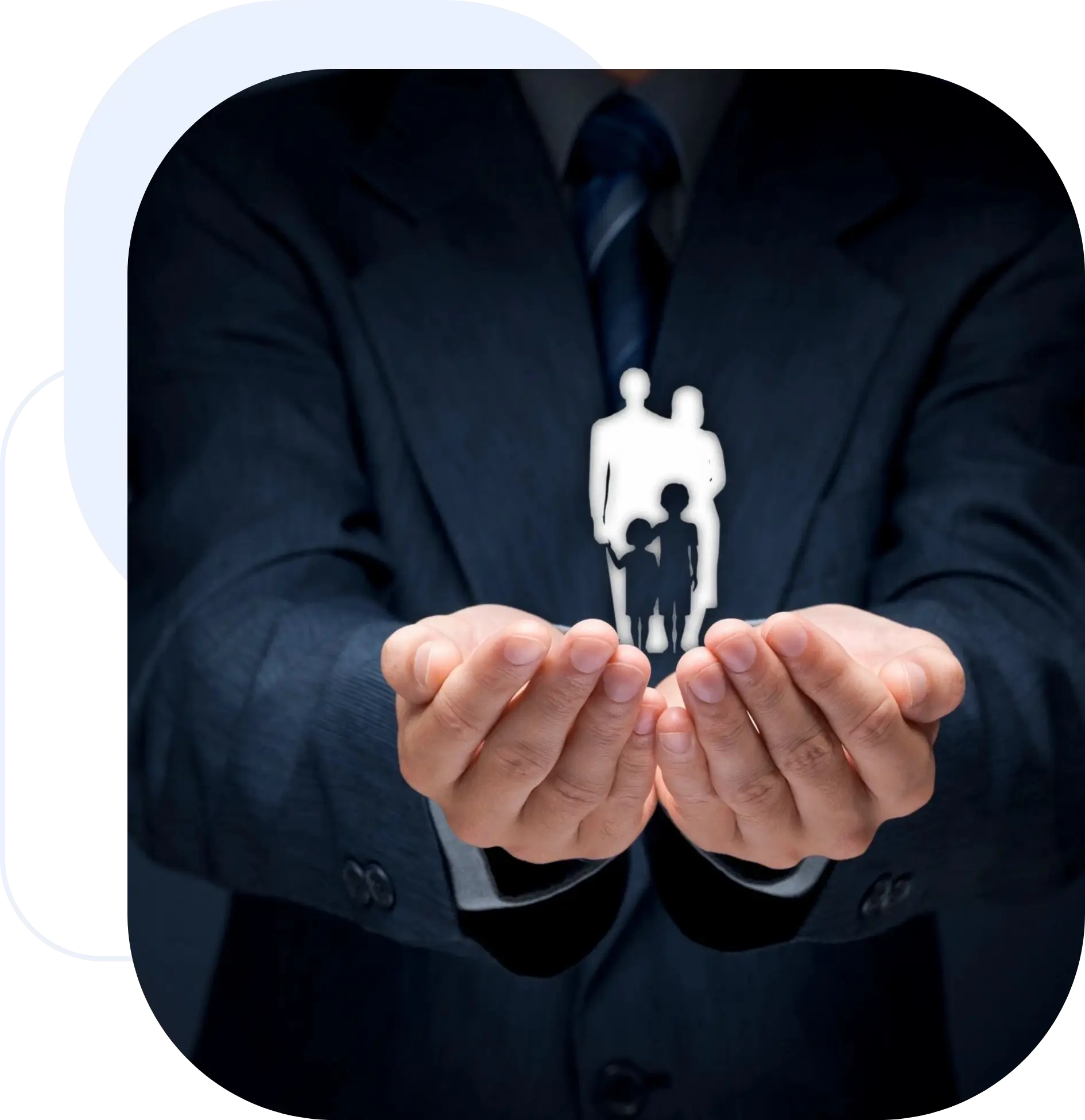 A businessman holding paper cutouts of two people.